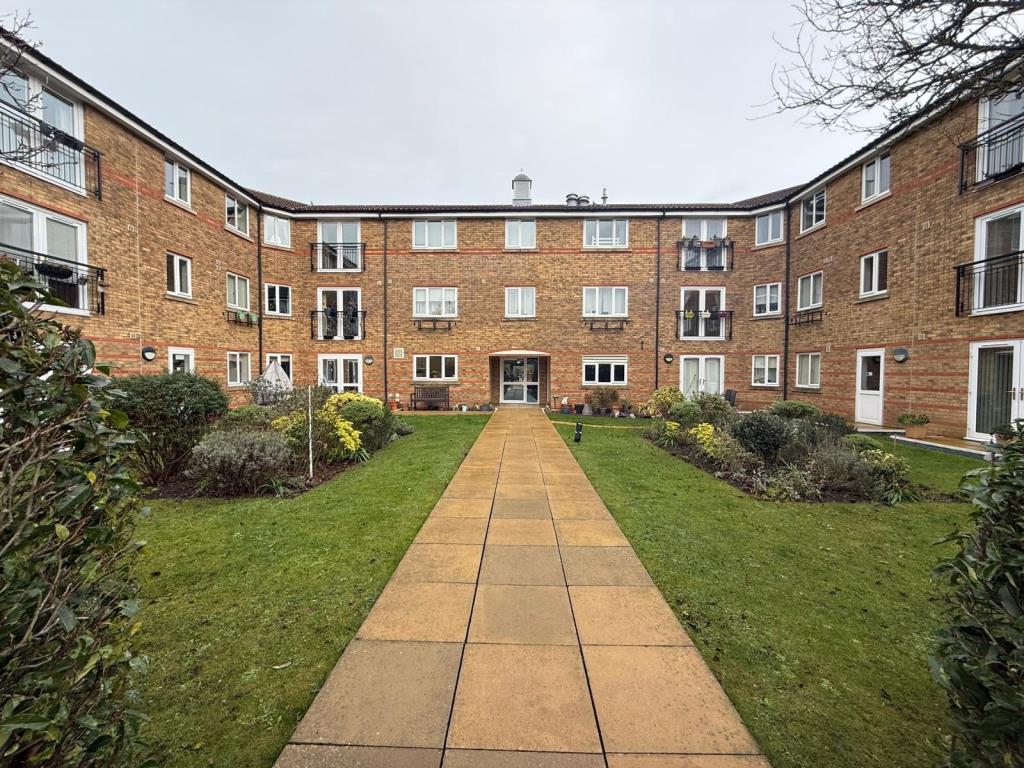 Lot: 50 - TWO-BEDROOM RETIREMENT FLAT IN NEED OF IMPROVEMENT - Back view of building from communal gardens